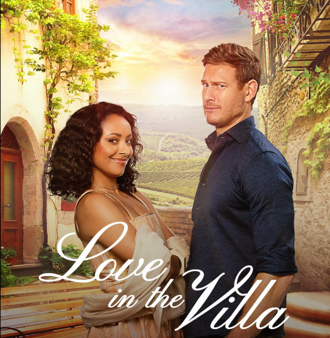Charlie looks skeptical as Julie smiles next to him. They are in front of a picturesque scene of Verona. I cursive letters it says LOVE IN THE VILLA