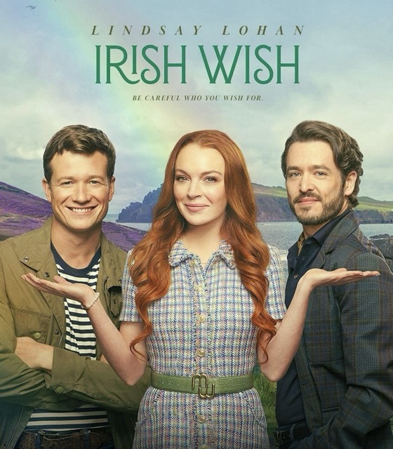 Maddie standing between James and Paul with her hands facing palm up under each of their faces. Behind them is the loc and purple fields of flowers, the cliffs of moher, and a rainbow. The text reads: Lindsay Lohan Irish Wish Be Careful What You Wish For